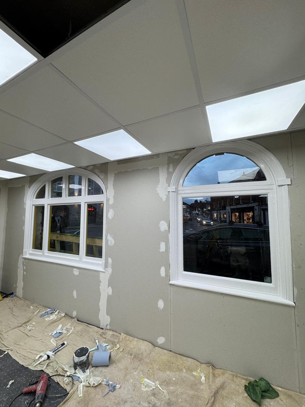 Shop interior after work: new ceiling, boarded walls and white arched windows